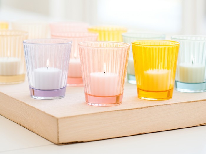 Votives glowing in clear pastel jars.