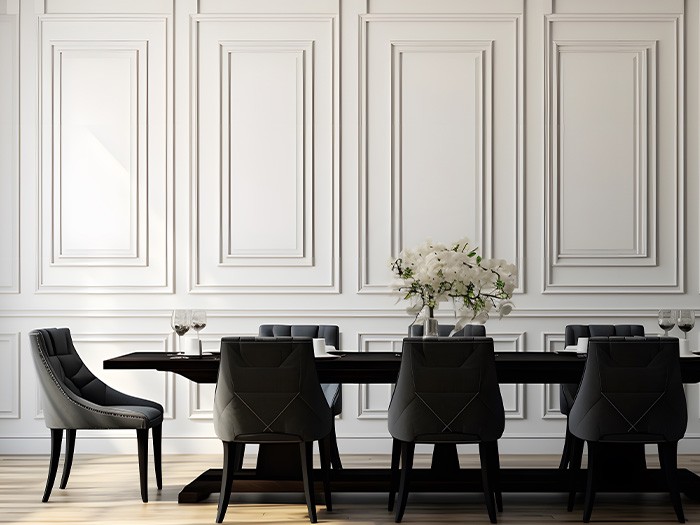 Wall trim/molding sets the background for a dining room table.